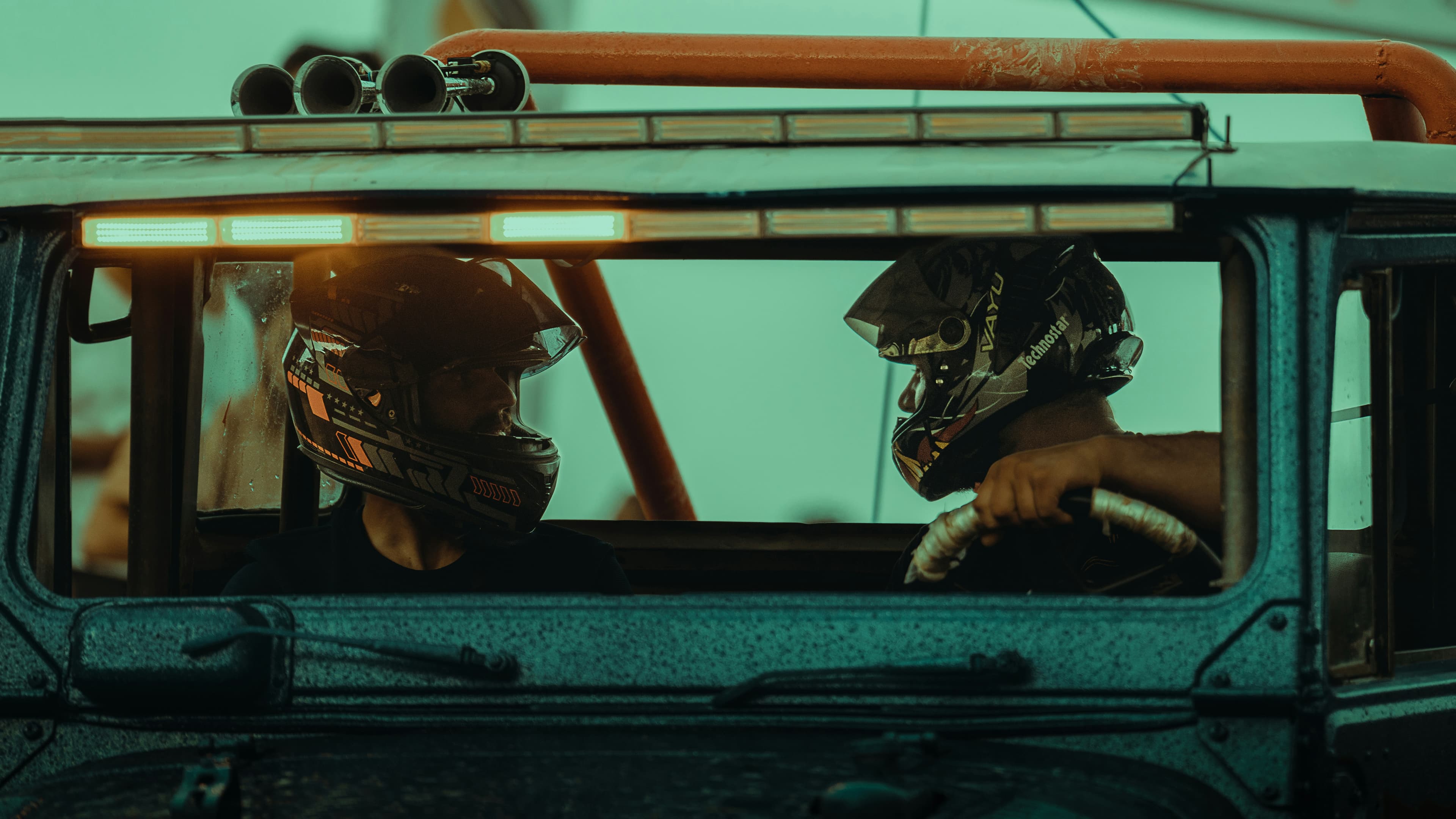 2 guys in helmets and fj looking at each other