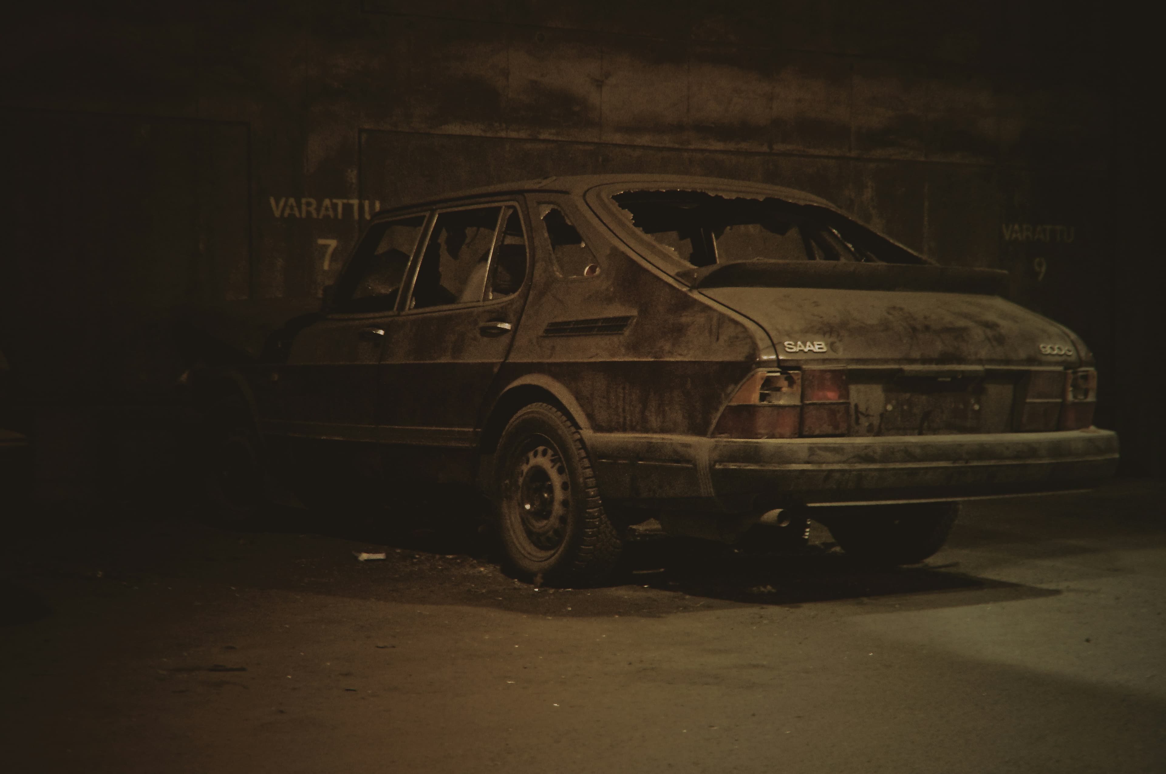 rundown saab in a dark alley