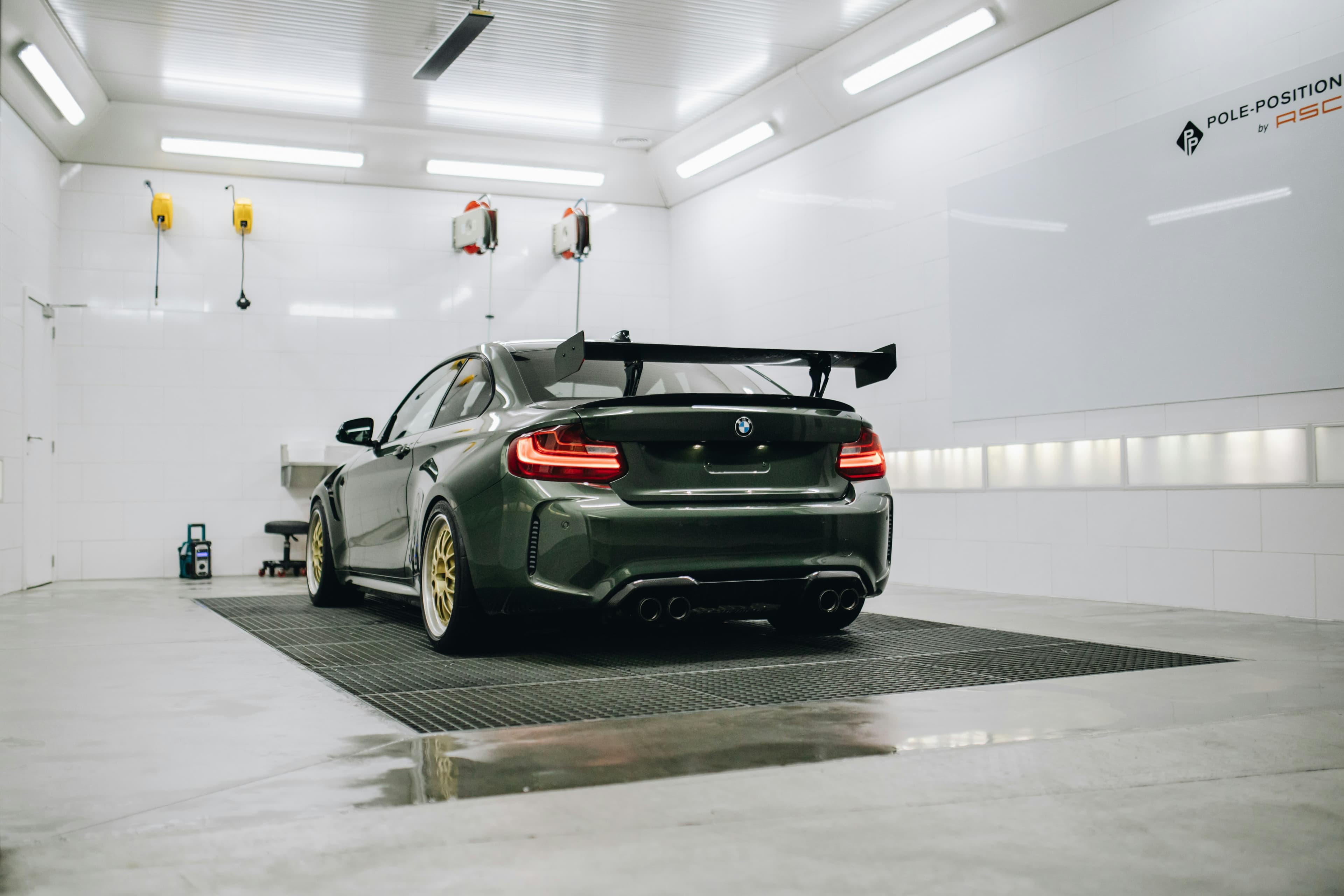 green and gold m2 with wing in white garage