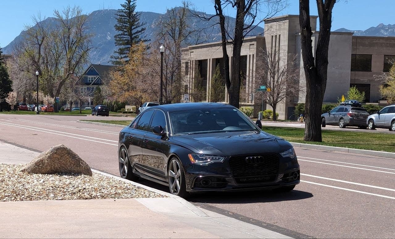 black audi a6 in front of a public building